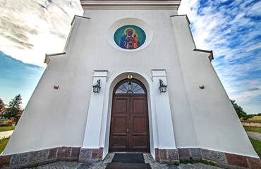 Wall Mural - General view and close-up of architectural details of the St. Stanislaus Catholic Church built in 1905 in Sieluń, Masovia, Poland.