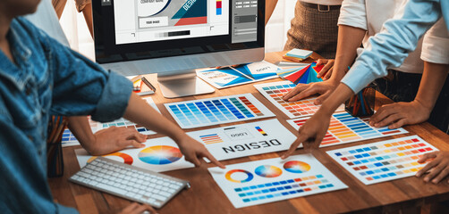 Poster - Graphic designer brainstorming logo and graphic art at busy artistic workshop, laptop display workspace. Experimenting color palette and pattern for creative design. Panorama shot. Scrutinize