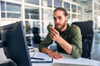© Valerii Apetroaiei - A man working as a call center operator in an office