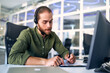 © Valerii Apetroaiei - A man working as a call center operator in an office