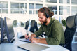 © Valerii Apetroaiei - A man working as a call center operator in an office