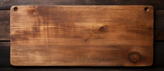 Aufkleber - old cutting board on a dark wooden table. The view is from above and space available for copying.