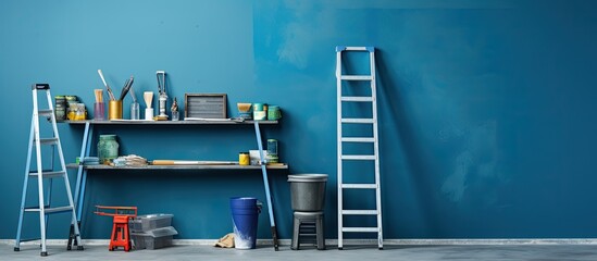Aufkleber - A table near a blue wall holds a metallic folding ladder and painting tools. space available