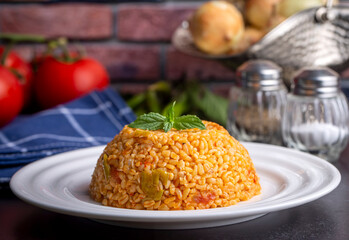 Traditional turkish bulgur pilaf with tomato sause in plate (Turkish name; meyhane pilavi)