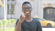 © stockbakers - Outdoor Portrait of Young African Man Pointing at Camera