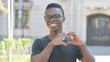 © stockbakers - Outdoor Portrait of Young African Man with Handmade Heart