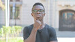 © stockbakers - Outdoor Portrait of Brainstorming Young African Man, Thinking