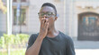 © stockbakers - Outdoor Portrait of Yawning Young African Man