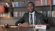 © stockbakers - Serious African American Lawyer Sitting in Office