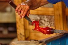 Murano Glass Blower Holds A Red Hot Glass Horse Sculpture