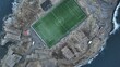 Aerial view of a football court on a rocky peninsula