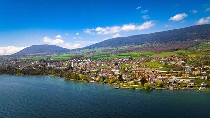 Wall Mural - a body of water surrounded by a forest filled hillside and given with mountains