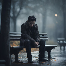 Sad Man Sitting On A Bench In The Rain, Generative Ai. 