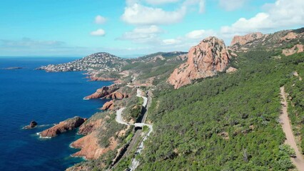 Poster - Drone footage of Massif de l'Esterel coastal mountain range with green forest on a sunny day, France