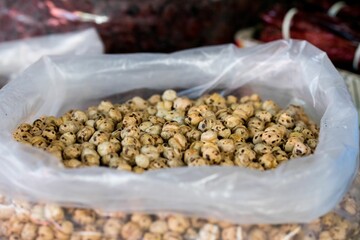 Canvas Print - A large bag of dried chickpeas for sale by a nuts and fruit vendor at a green market in Macedonia