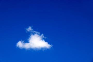 single white cloud in blue sky. bright blue sky with white puffy clouds