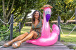 © Marino Bocelli - portrait of beautiful middle aged woman sitting on flamingo inflatable toy