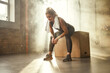 © Friends Stock - Hard workout. Tired athletic woman with perfect body in sports wear wearing towel on her shoulders while sitting at gym after workout