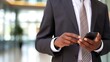 © thesweetsheep - Businessman using a cell phone, closed up hand