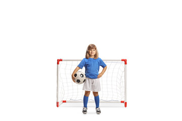 Sticker - GIrl in a football jersey posing with ball under arm in front of a mini goal