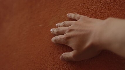 Sticker - Slow motion man hand touching terracotta wall