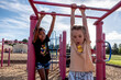 © Cavan Images - School aged children playing on monkey bars