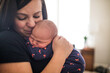 © Cavan Images - Close up of mother holding her newborn baby boy.