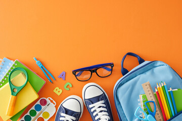 Well-prepared for academic achievements. Top view shot of school materials, colorful letters, eyeglasses, trendy sneakers, child's rucksack on orange background with empty space for advert or text