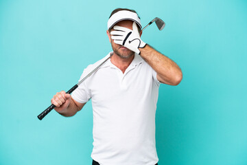 Middle age caucasian golfer player man isolated on blue background covering eyes by hands. Do not want to see something