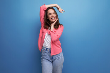 Wall Mural - portrait of stylish dark haired young woman with hollywood smile isolated with studio background