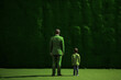 © alisaaa - Unrecognizable father and son standing, against artificial green