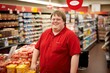 shop assistant with down syndrome posing standing in front of the camera.