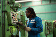 © KANGWANS - African American worker in  factory. Maintenance and repairing work in modern industry concept.