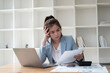 © PaeGAG - Exhausted Asian businesswoman feeling tired and stressed while working against her dealing in the office room.