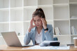 © PaeGAG - Exhausted Asian businesswoman feeling tired and stressed while working against her dealing in the office room.