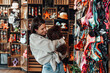 © Dusko - Beautiful young woman enjoying in modern pet shop together with her adorable brown toy poodle.