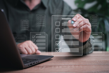 Smart checklist Businessman document management concept, Businessman takes an assessment checks on digital checklist and uses a laptop to manage documents online in a storage system with paperless