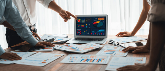 Leinwandbilder - Panorama shot analyst team utilizing BI Fintech to analyze financial report with laptop. Businesspeople analyzing BI power dashboard displayed on laptop screen for business insight. Scrutinize