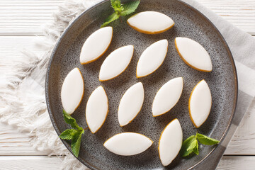 Calissons French glazed almonds bonbons with white icing closeup on the table. Horizontal top view from above