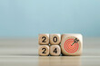 2024 year with the target which prints screens on wooden cube blocks with ideas for Business plans and goals and strategies that will lead to business success and a better life in the new year.