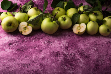 Wall Mural - Fresh ripe green apple in purple background.