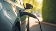 © Studio Nova - EV Car or Electric car at charging station with the power cable supply plugged in on blurred nature with soft light background. Created with Generative AI technology.