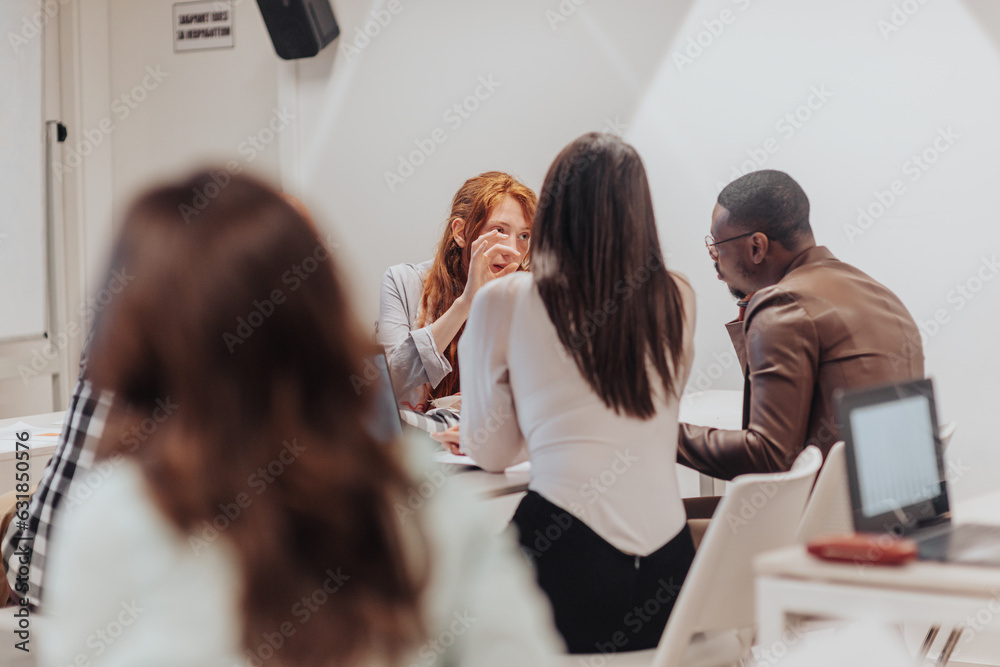 Young multiracial employees brainstorming at the office, discussing ...