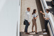 © qunica.com - Three businesspeople talking outside