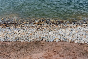 Poster - Tranquil beachfront view of a rocky shoreline situated along a picturesque cliff