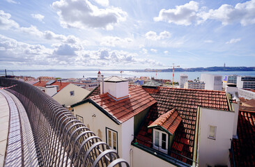 Wall Mural - Beutiful view of old town in Lisbon. Red tiled roofs and blue sky.