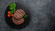 Grilled beefsteaks cutlets patties on a dark background, Long banner format. top view