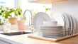© kichigin19 - a stack of clean washed dishes in the kitchen indoor.