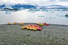  Joekulsar Lagoon With Icebergs  And Eroding Glacier In Iceland And Empty Canoes At The Beach For Rent