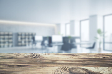 Wall Mural - Close up of empty wooden desktop with product placement mock up place on blurry office interior backdrop. 3D Rendering.